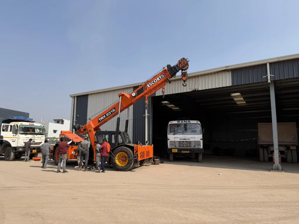 Crane unloading construction materials at warehouse